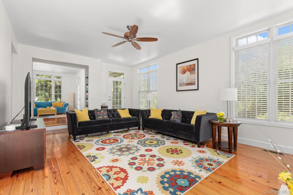 The sun-filled living room offers a versatile space designed for today’s work-life balance. Flowing seamlessly into the sitting room and kitchen, its 