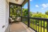 Accessible from both the sitting room and living room, this private balcony offers a peaceful retreat to relax with a good book or enjoy afternoon tea