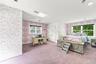 Spacious interior featuring patterned wallpaper, recessed lighting, carpeted flooring, and dual double-pane windows