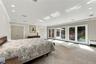 Expansive room featuring recessed lighting, dual closets, and three sets of double glass doors