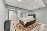 Vertical paneling, wood-finish flooring, recessed lighting, and a drop ceiling