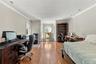 Spacious room featuring wood-finish flooring, recessed lighting, crown molding, and an octagonal accent window