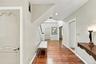 Foyer featuring wood-finish flooring, recessed lighting, and arched-panel interior doors