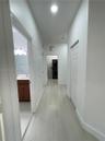 Hallway featuring light-toned wood-finish flooring, recessed lighting, and white six-panel closet doors