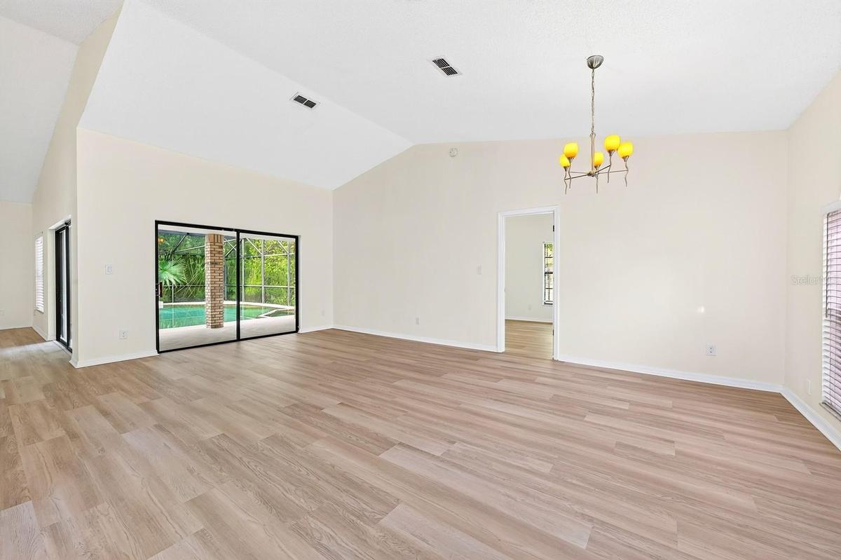 In the Living Room, sliding glass doors open to the PATIO AND POOL AREA—perfect for entertaining or enjoying a relaxed evening at home.