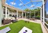 Screened backyard with Astroturf