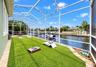 Screened backyard with Astroturf