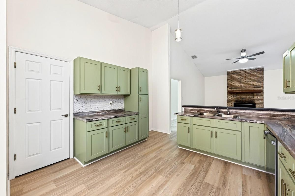 The beautifully REFRESHED KITCHEN offers an abundance of NEW CABINETRY and counter space, a convenient breakfast bar and NEW STAINLESS STEEL APPLIANCE
