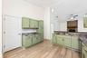 The beautifully REFRESHED KITCHEN offers an abundance of NEW CABINETRY and counter space, a convenient breakfast bar and NEW STAINLESS STEEL APPLIANCE