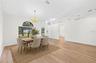 The formal Dining Room features an ELEGANT ARCHED LUNETTE WINDOW and flows into the Living Room. Virtually Staged