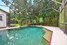The in-ground pool and screened lanai create the perfect setting for swimming, relaxing and entertaining year-round.