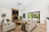 In the Family Room, a WOOD-BURNING FIREPLACE creates a cozy focal point, and sliding glass doors provide another EASY CONNECTION to the outdoor living