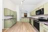 The beautifully REFRESHED KITCHEN offers an abundance of NEW CABINETRY and counter space, a convenient breakfast bar and NEW STAINLESS STEEL APPLIANCE