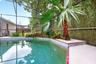 The in-ground pool and screened lanai create the perfect setting for swimming, relaxing and entertaining year-round.