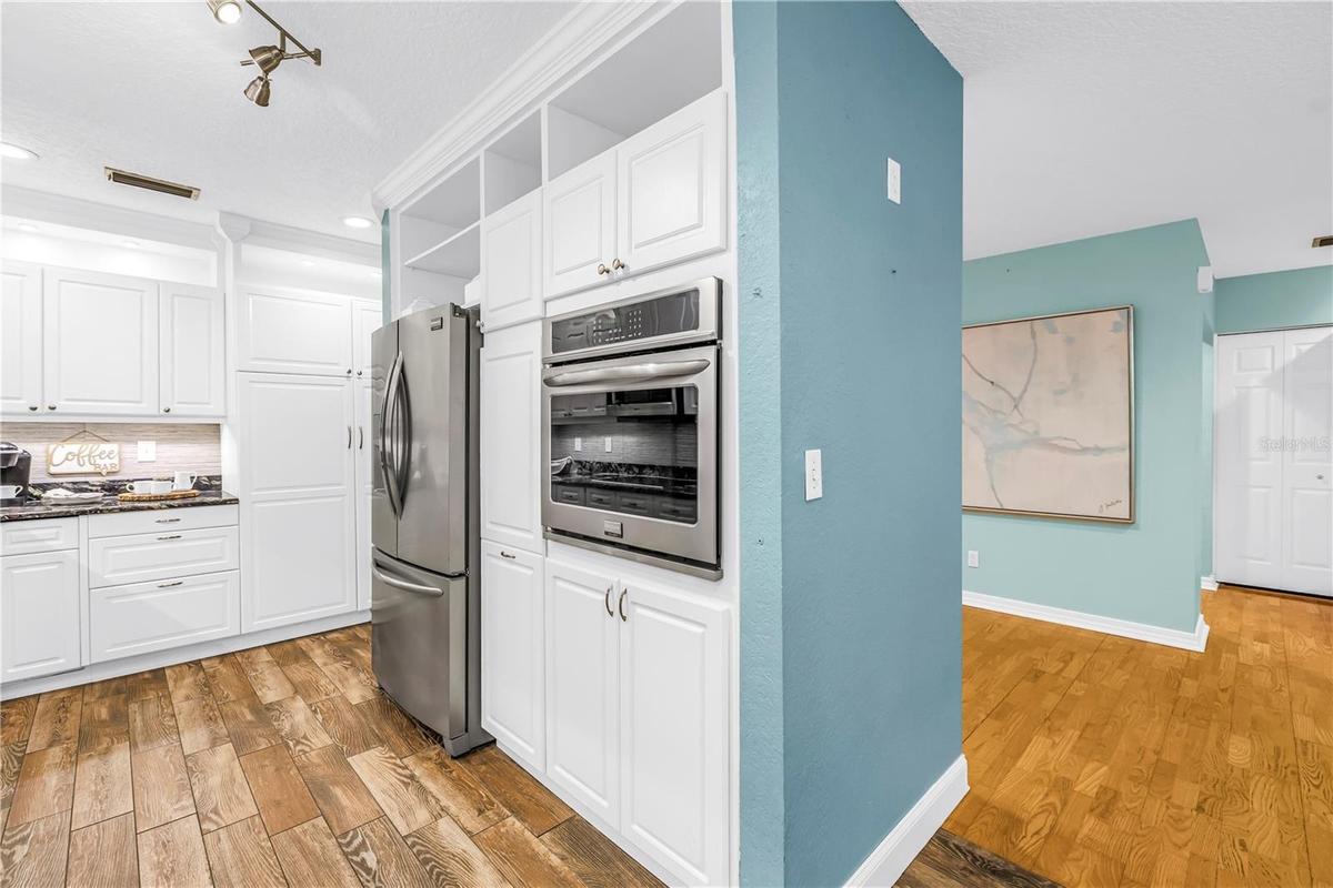 The separate kitchen console housing the refrigerator and wall oven provides added convenience and increased storage capacity.