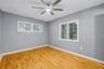 Spacious second bedroom with energy-efficient dual-pane windows, natural light, noise reduction, private half bathroom, and an expansive walk-in close