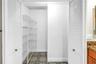 The primary suite features an expansive walk-in linen closet, updated with flooring that matches the primary bath floor.