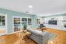 Spacious, casual living area adjacent to the kitchen, featuring direct views of the heated pool—an ideal setting for entertaining and watching the gam