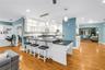 Modern lighting, illuminated cabinetry, sun tubes for natural light, and a dedicated built-in study/management area.