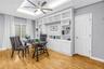 The fourth bedroom features direct access to the hallway bathroom and includes a built-in credenza. The space offers privacy while remaining connected