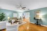 Formal living room with elegant crown molding, modern paint, updated fixtures, and an open layout in an exceptionally well-maintained home.
