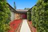 A sandstone-accented courtyard and foyer connect to a generously sized living and dining area.
