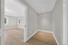 Neutral-toned interior featuring wood-finish flooring, recessed lighting, and white door casings