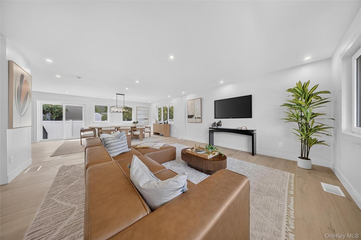 Open-concept interior featuring recessed lighting, wood-finish flooring, and multi-pane windows