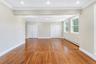 Room featuring wood-finish flooring, recessed lighting, crown molding, and dual closets with white paneled doors