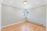 Neutral-toned interior featuring hardwood flooring, crown molding, recessed lighting, and a modern circular flush-mount ceiling fixture