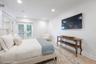 Virtually Staged Lower level bedroom/tv room with doors to the yard.