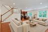 Sun-filled and spacious, the main level is designed for modern living with oversized windows, hardwood floors, a gas fireplace, and seamless flow betw