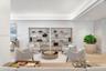 Built-in floor-to-ceiling shelving, recessed tray ceiling with cove lighting, and neutral wood-finish flooring