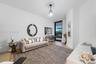 Room featuring wood-finish flooring, a contemporary glass pendant light fixture, and a floor-to-ceiling glass door