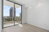 Floor-to-ceiling glass sliding door, balcony with railing, wood-finish flooring, and recessed ceiling lighting