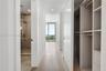 Hallway featuring light-toned wood-finish flooring, recessed lighting, and custom built-in cabinetry with integrated shelving and drawers