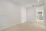 Neutral interior space featuring high-contrast recessed lighting, wall-to-wall carpeting, and crisp white finishes
