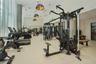 Fitness center featuring floor-to-ceiling windows, high ceilings, full-wall mirrors, recessed lighting, and metallic dome pendant fixtures