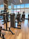 Fitness center featuring floor-to-ceiling windows, wood-finish flooring, recessed lighting, and mirrored wall surfaces
