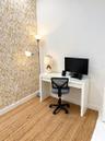 Accent wall featuring a botanical-patterned wallpaper and white flooring