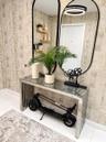 Textured neutral-toned wallpaper, dual floor-to-ceiling arched mirrors with black metal framing, built-in wooden wall shelving, and polished tile floo