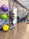 Fitness center featuring wood-finish flooring, floor-to-ceiling mirrored walls, and graphic wall mural