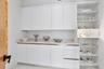 A dedicated, custom-shelved China Closet beautifully houses fine china, crystal, glassware and treasured collections—an exceptional detail for those w
