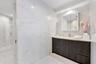 The rosewood room offers Floor to ceiling European porcelain bathrooms with real oak wooden soft close cabinetry, modern vanities and a private water 