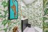 A hidden jewel at the end of the tropical hallway, this exceptionally private powder room is a delightful departure from the expected. Dramatic custom