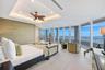 A dramatic freestanding wood sculpture adds an artistic focal point to the primary suite, where its organic form is framed by floor-to-ceiling glass a