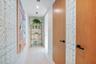 A Private Passage to the Aqua Guest Wing — Tucked away on the penthouse’s west side, a long private gallery hallway creates a wonderful sense of arriv