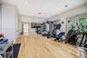 Room featuring wood-finish flooring, recessed lighting, expansive wall-to-wall mirrors, and dual sets of glass-paneled french doors