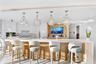 Exceptionally spacious and beautifully designed, this magnificent chef's kitchen transforms entertaining into an experience. The grand backlit Cristel