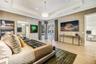 Tray ceiling with recessed lighting, wood-finish flooring, and glass-paned French doors